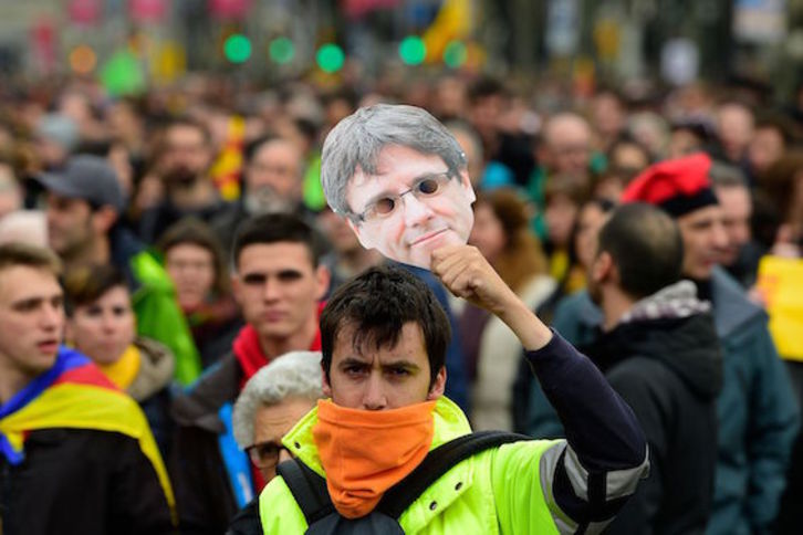 Un manifestante con la careta de Puigdemont, ayer, en la movilización de Barcelona. (Lluis GENÉ/AFP)